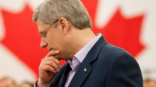 Stephen Harper pauses as he speaks during a visit to a factory in Dieppe, N.B., on Friday April 1, 2011. (Adrian Wyld / THE CANADIAN PRESS)