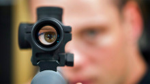 Patrick Deegan, a senior range officer at the Shooting Edge, looks through the scope of long gun at the store in Calgary, Wednesday, Sept. 15, 2010.