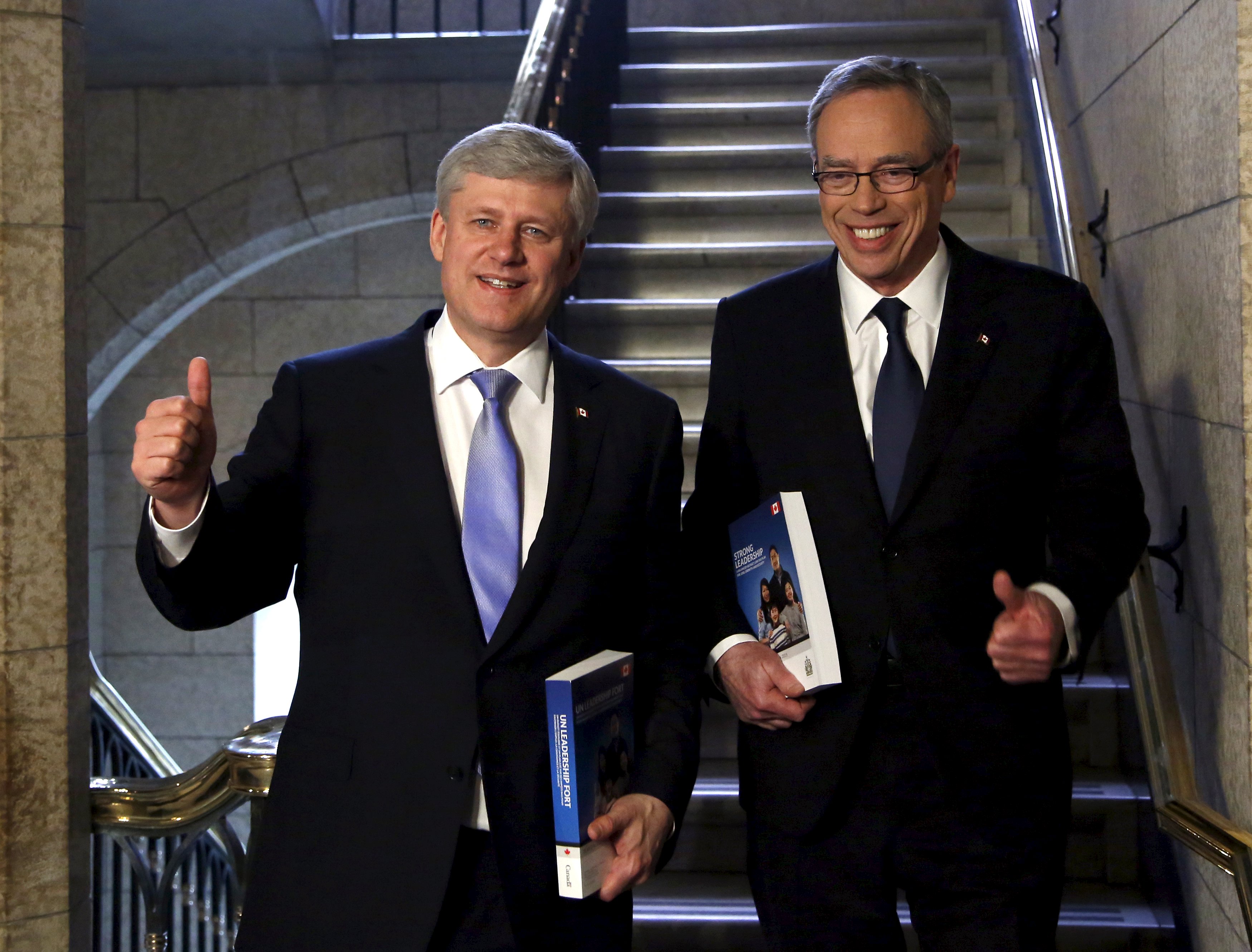 Canada's PM Harper and Finance Minister Oliver walk to the House of Commons to deliver the federal budget in Ottawa